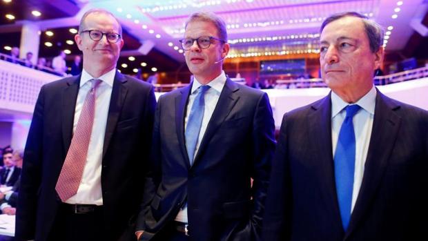 (De izda a dcha: El CEO del Commerzbank, Martin Zielke, junto a su homólogo del Deutsche Banki, Chirstian Sewing y el presidente del BCE, Mario Draghi