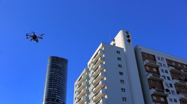 Imagen de un dron surcando el cielo junto a unos edificios
